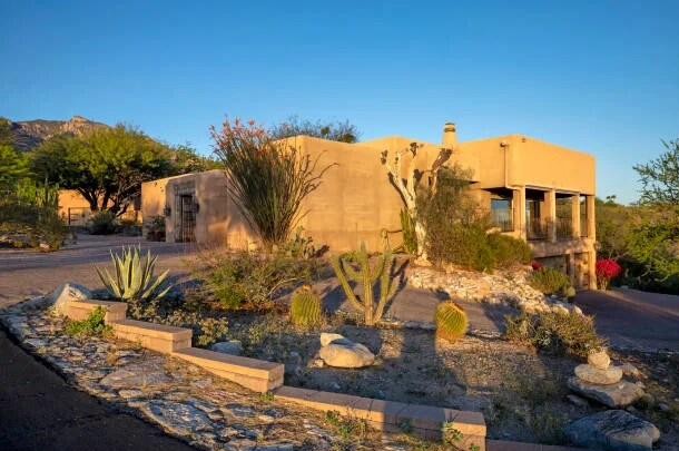 Adobe-style home with cactus and agave xeriscape garden